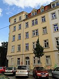 Apartment house in a corner and closed development