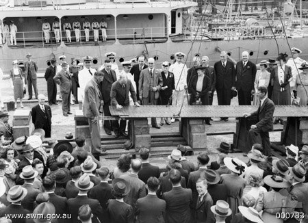 Stewart puts a rivet in the keel of HMAS Bathurst at the keel laying ceremony at Cockatoo Dockyard, Sydney, 10 February 1940