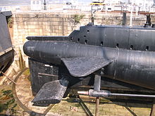 Stern planes of HMS Ocelot mounted directly in the prop wake, with fixed planes above. HMS Ocelot 1962 side view of stern.JPG