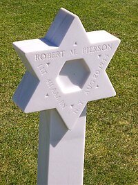 Grave of a Jewish American soldier at Normandy. An inscription on the stone reveals that the soldier was a first lieutenant from New York who served in the 411th Antiaircraft Artillery Gun Battalion. Jewishsoldiergrave.jpg