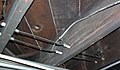 Wiring running through tubes, and turning a corner supported by a knob. Notice the direct splice with more modern (1950s-era) non-metallic sheathed cable. This type of connection is forbidden by the National Electrical Code, and a junction box should have been used.