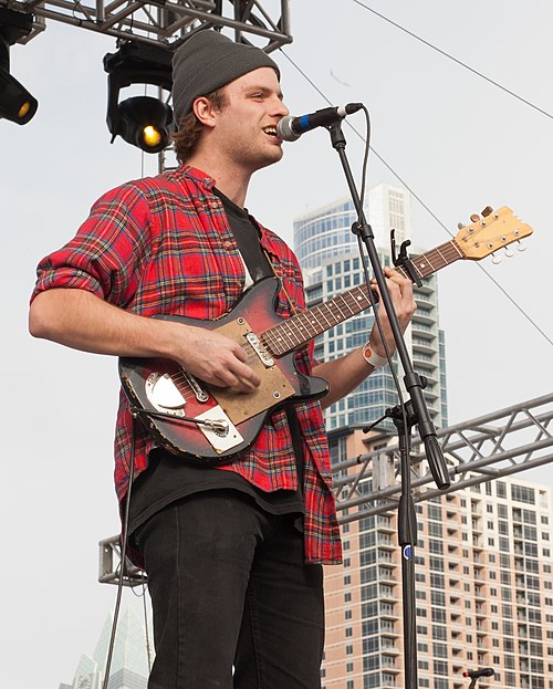 DeMarco performing with his Teisco electric guitar (2013)