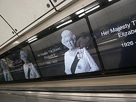 A photo of Elizabeth II on a series of screens