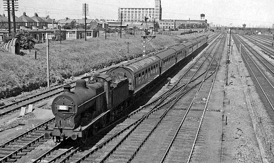 Derby – Lowestoft holiday express approaching by the Midland's Melton Mowbray line in 1962