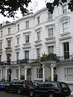 A color photograph of a white, multi-story building.