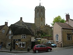 Street scene showing houses with octagonal church tower behind