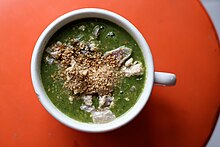 Spinach soup with garnishes