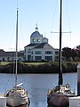 Suisun City Hall as seen across Suisun Slough between two boats in the harbor.jpg