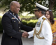 Commodore Alok Bhatnagar (right) of the Indian Navy is received as guest of honor by Major General Vincent R. Stewart at the 2013 Sunset Parade. Sunset Parade 130625-M-KS211-040.jpg