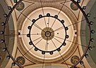 Intricate inscriptions surround the interior of a dome shot from below