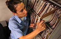 US Navy 041019-N-5821P-019 Airman Lauren Thurgood of Las Vegas, Nev., pulls patient medical records in the inpatient ward aboard the conventionally powered aircraft carrier USS Kitty Hawk.jpg
