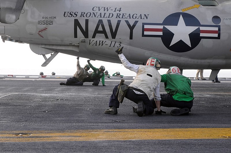 File:US Navy 090706-N-3610L-010 Two final checkers give flight deck training to two trainees as they perform a final check on an E-2C Hawkeye.jpg