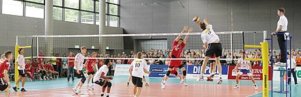 White is on the attack while red attempts to block. Volleyball pano IMG 0658.JPG