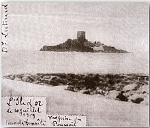 Photographie noir et blanc d'une île avec une tour en cours de construction.