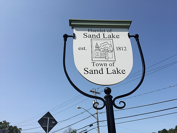 Sign for the Hamlet of Sand Lake within the Town of Sand Lake, New York