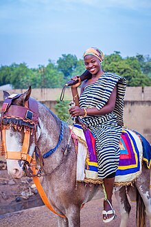 A Dagomba lady on a horse. A beautifullly Dagomba Woman dressed in Kente in Northern Ghana 05.jpg