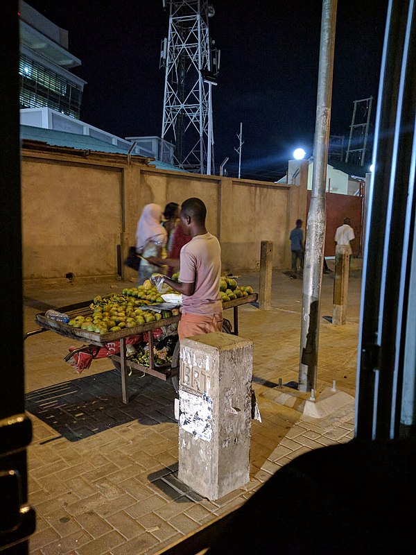 A vendor in Dar es Salaam selling fruit.