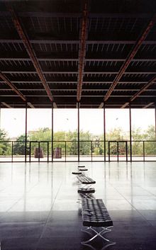 This interior view of the Neue Nationalgalerie's ground floor shows the play of light off the reflective floor, as well as the animated red LCD tracks on the ceiling.