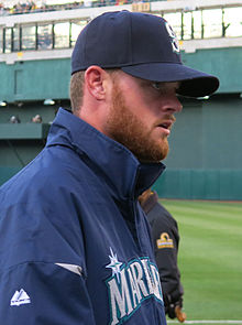 Seattle Mariners' Charlie Furbush, left, points out new socks as