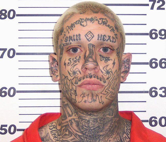 Man appears in court showing off white supremacy tattoos after arrest for  his role in 2016 murder