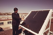 A New Mexico State University professor showing a solar panel in New Mexico in April 1974 DR. R.L. SAN MARTIN, NEW MEXICO STATE UNIVERSITY CLOSED COIL TYPE SOLAR HEATING PANEL - 555293 (cropped).jpg