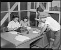 Granada Relocation Center, Amache, Colorado. A temporary timekeeping office is a busy spot as the f . . . - NARA - 538737.jpg