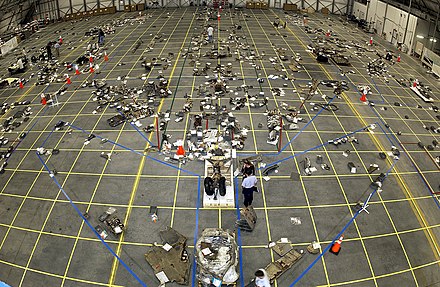 A grid on the floor is used to organize recovered debris