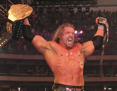 Triple H after winning the Undisputed WWF Championship (now WWE Championship) at WrestleMania X8; the former WCW Championship and WWF Championship belts represented the unified title until a single belt was presented to Triple H in April 2002