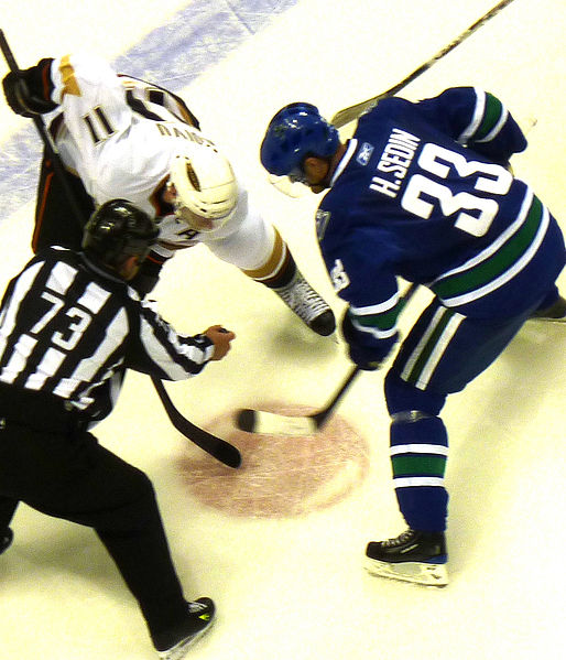 Saku Koivu of the Ducks, and Henrik Sedin of the Vancouver Canucks, face-off during a game in the 2009–10 season. The Ducks signed Koivu during the 20