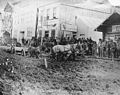 Horse drawn cart hauling lumber stuck in mud on Front St, Dawson, Yukon Territory, ca 1899 (HEGG 655).jpeg
