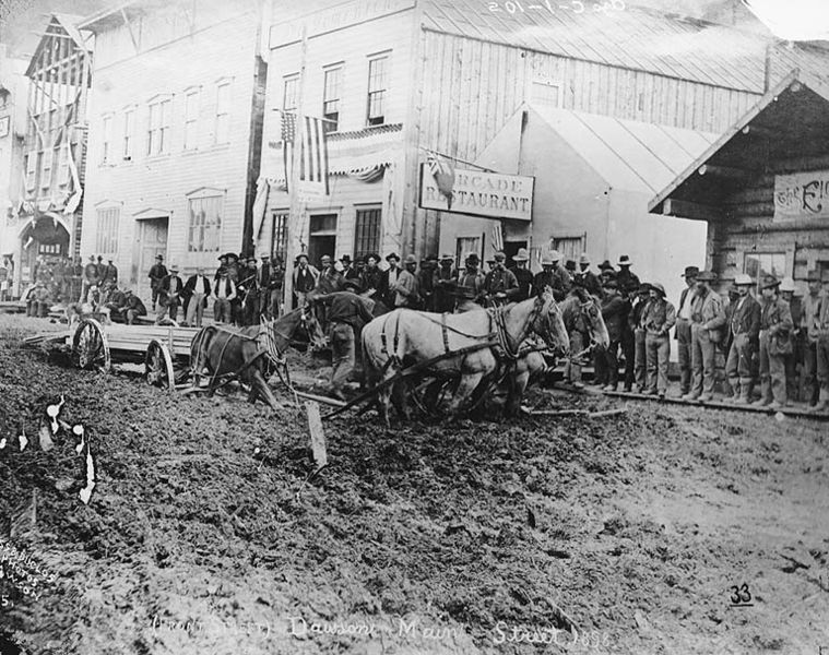 File:Horse drawn cart hauling lumber stuck in mud on Front St, Dawson, Yukon Territory, ca 1899 (HEGG 655).jpeg