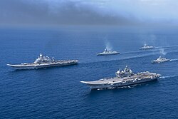 Aircraft carriers INS Vikramaditya (R33) and INS INS Vikrant (R11) with fleet ships and submarines. INS Vikrant (R11) and INS Vikramaditya (R33) with the carrier battle group.jpg