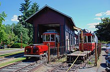 The carbarn in 2014, with Brill car 519 pulling in at the end of the day. At right is ex-Milan car 96, which was never operated in Issaquah. Issaquah Valley Trolley carbarn - north end, with car 519 pulling in and Milan car 96 outside (2014).jpg