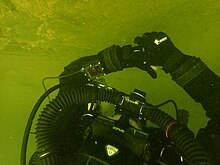 The diver is provided with information on the status of the breathing gas in the loop on the wrist mounted display and sometimes also on a head-up display as can be seen on the mouthpiece of this JJ electronically controlled closed circuit rebreather. JJ Rebreather at Blue Rock Quarry PC290157.jpg