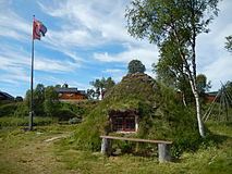 Goahti and flag in Mittådalen by the stream Mittån.