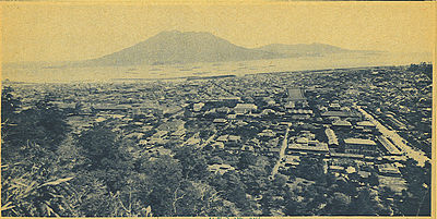 The city covered deep in ash after the 1914 eruption of the Sakurajima volcano which is seen in the distance across the bay