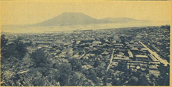 The city covered deep in ash after the 1914 eruption of the Sakurajima volcano which is seen in the distance across the bay