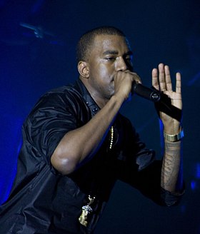 A photograph of Kanye West performing live.