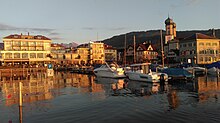 The marina of Lachen at sunset. Due to its western-facing position, Lachen is known as the "town with the best sunset-views on lake Zurich". Lachen Marina.jpg