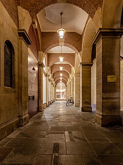 Beco entre a Casa de vinhos da cidade de Münster (Stadtweinhaus) e a Prefeitura, Renânia do Norte-Vestfália, Alemanha. A Casa de vinhos, no Prinzipalmarkt, é um anexo representativo da histórica prefeitura de Münster do século XVII e um dos marcos da cidade. Foi construída em 1615/1616 no governo do primeiro prefeito e é a única dependência sobrevivente da prefeitura, mas é arquitetonicamente muito independente e elegante. Ela está localizada ao norte da atual prefeitura, separada dela apenas por um beco estreito. Originalmente servia como depósito do vinho da cidade, que antes era armazenado nas adegas da prefeitura. (definição 4 466 × 4 466)