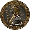 A gold-and-silver coin featuring the bust of a crowned man in armour, holding a sceptre and a sword. The bust is surrounded with the text 'Maximilianus Dei Gra Rex & Imper Augustus'.