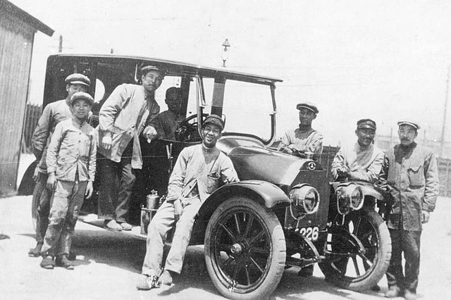 Workers at Mitsubishi Shipbuilding Co., Ltd, alongside one of the prototype Mitsubishi Model A automobiles (1917)