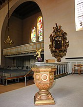 The richly decorated epitaph in Baroque style on the east wall above the choir organ is attributed to the workshop of the sculptor Lorentz Jørgensen, who is well known in the Holbæk region.  The painting (around 1649) shows City Councilor Peter Jensen (1583–1649) and his wife Margrethe Nielsdatter kneeling in prayer on a metal plate