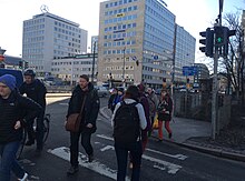 Pedestrians crossing outside hotel (41151735335).jpg