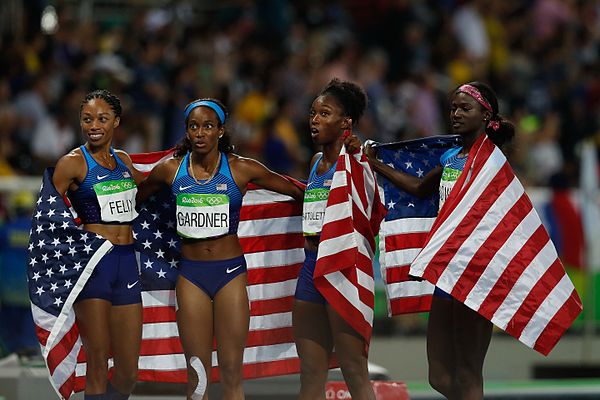 Allyson Felix, English Gardner, Tianna Bartoletta, and Tori Bowie celebrate their victory in the women's 4 × 100 m relay at the 2016 Rio Olympics.