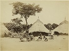 Women in front of traditional Azande homes, ca. 1880 Richard Buchta - Zande homestead with women.jpg