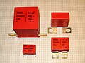 Film capacitors with broader and larger terminals for "snubber" applications with high pulse loads