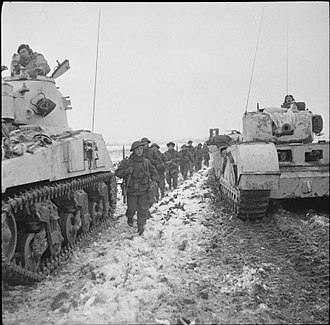 Men of the 4th/5th Battalion, Royal Scots Fusiliers pass between a Sherman and a Churchill tank during the 52nd Division's attack towards Stein from Tuddern, 18 January 1945. The British Army in North-west Europe 1944-45 B13788.jpg