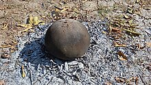 Umbadiyu being cooked in an upside down earthen pot Umbadiyu at home.jpg