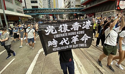 On 1 July 2020, the day after implementation of the security law, tens of thousands of Hong Kong people gathered on the streets in Causeway Bay to march. On 2 July, the Hong Kong government declared the 'Liberate Hong Kong, revolution of our time' slogan depicted on a banner here – "the most resonant slogan of its protest movement" – to be subversive and in violation of the law.[129]